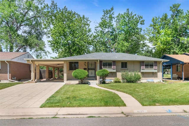1637 S Stuart St, Denver, CO 80219 - view of front of property with brick siding, concrete driveway, a front yard, and an attached carport