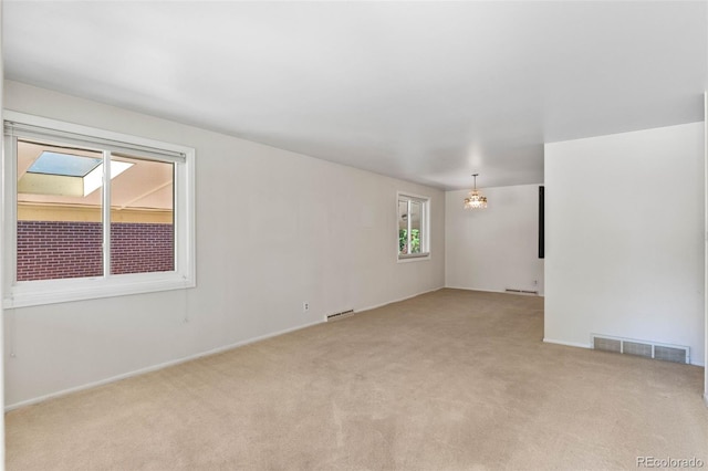 1637 S Stuart St, Denver, CO 80219 - carpeted empty room with a chandelier and baseboards