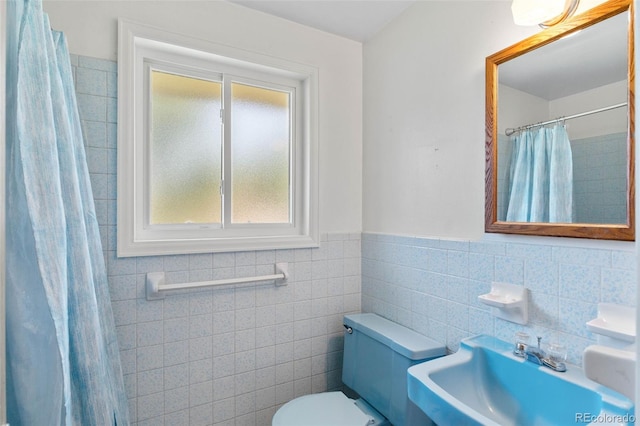 1637 S Stuart St, Denver, CO 80219 - bathroom featuring healthy amount of natural light, tile walls, wainscoting, and a shower with shower curtain