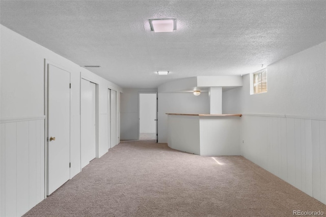 1637 S Stuart St, Denver, CO 80219 - basement featuring a textured ceiling, carpet flooring, and wainscoting