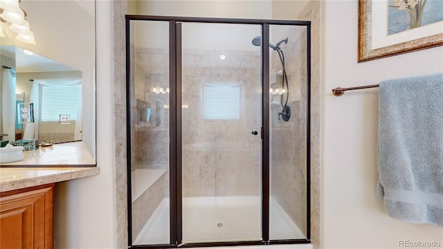 bathroom with an enclosed shower and vanity