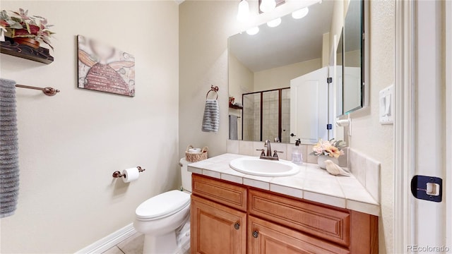 bathroom featuring vanity, an enclosed shower, tile patterned floors, and toilet