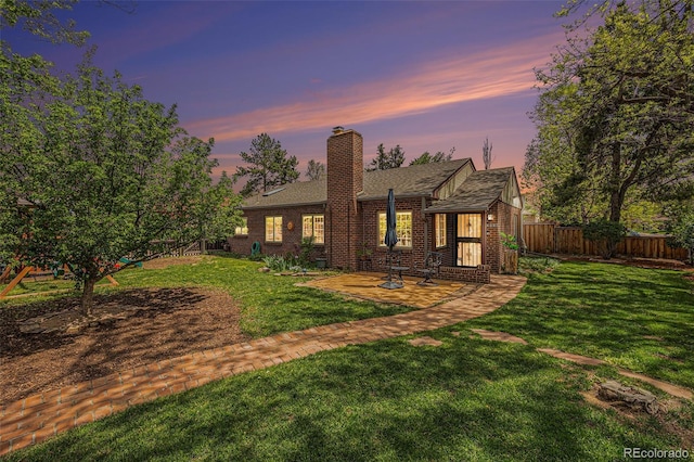 1900 Magnolia St, Denver, CO 80220 - view of front of property with brick siding, a chimney, a patio, and roof with shingles