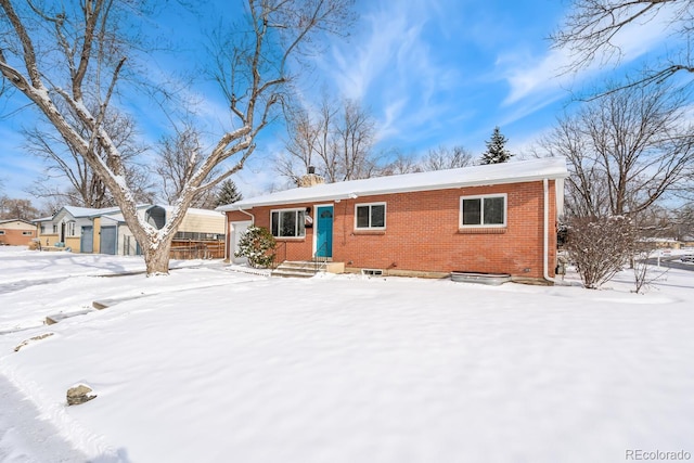 view of front of home featuring a garage and brick siding