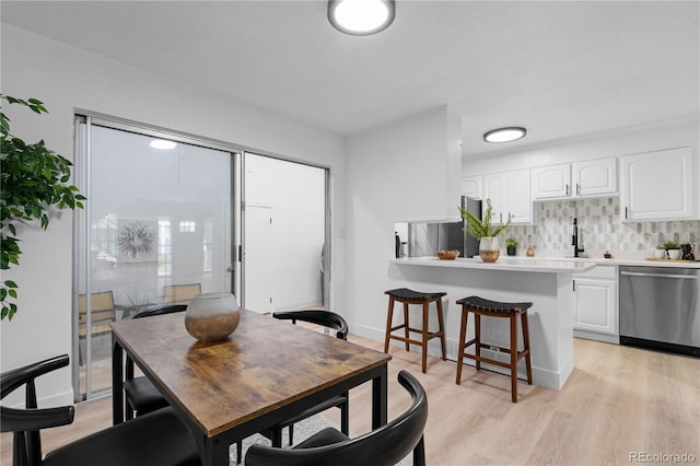 dining area featuring light wood-type flooring