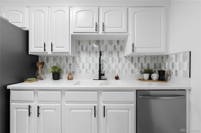 bar with stainless steel dishwasher, a sink, freestanding refrigerator, and tasteful backsplash