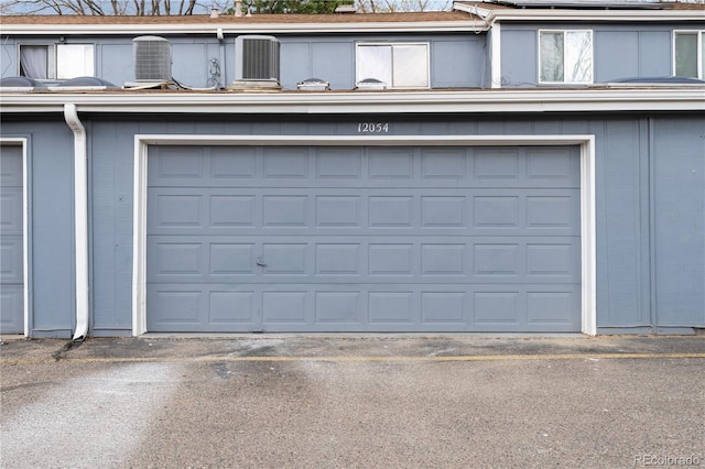 garage with solar panels and driveway