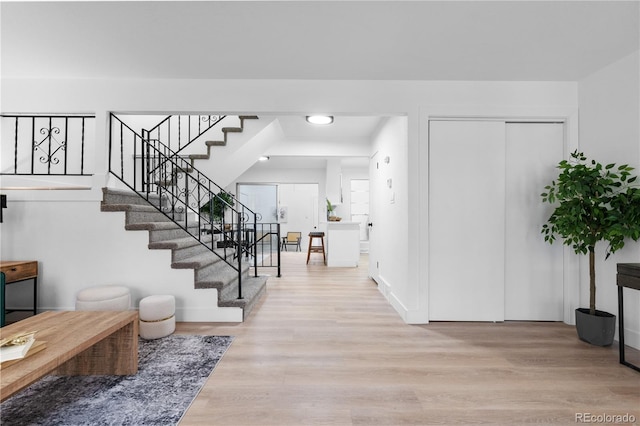 entrance foyer featuring stairway, baseboards, recessed lighting, and wood finished floors