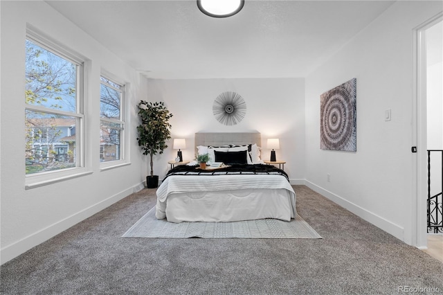 bedroom featuring baseboards and carpet