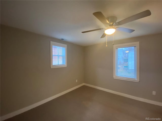 spare room with carpet and ceiling fan