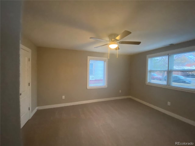 spare room with plenty of natural light, ceiling fan, and carpet flooring