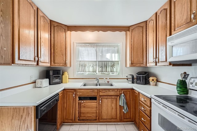 kitchen with light tile patterned floors, white appliances, and sink