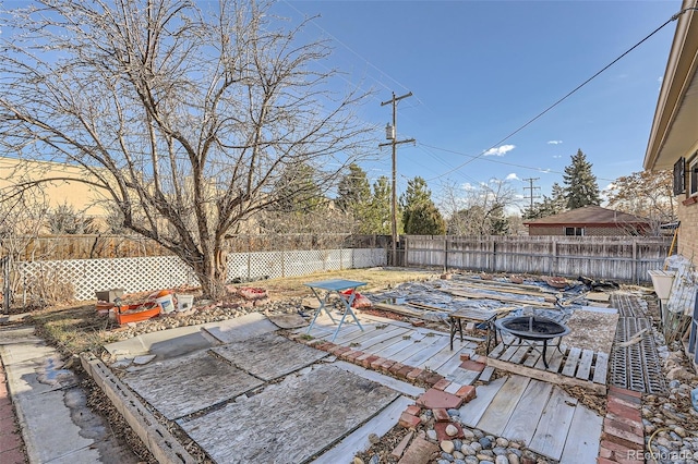 view of patio featuring a fire pit and a wooden deck