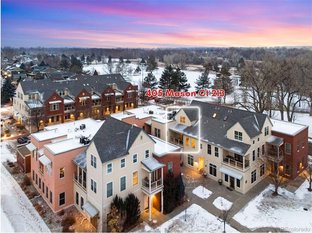 snowy aerial view featuring a residential view