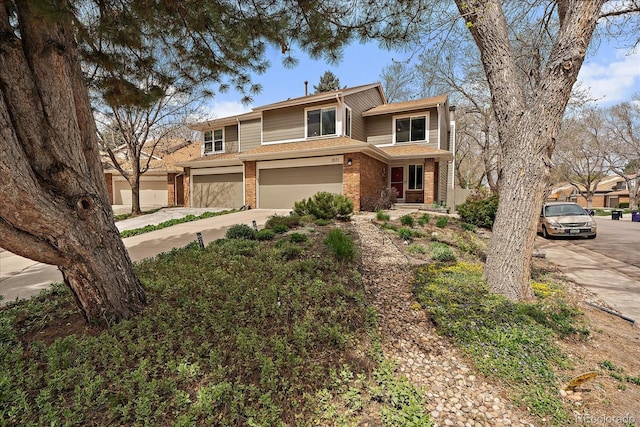 view of front of house featuring a garage, concrete driveway, and brick siding