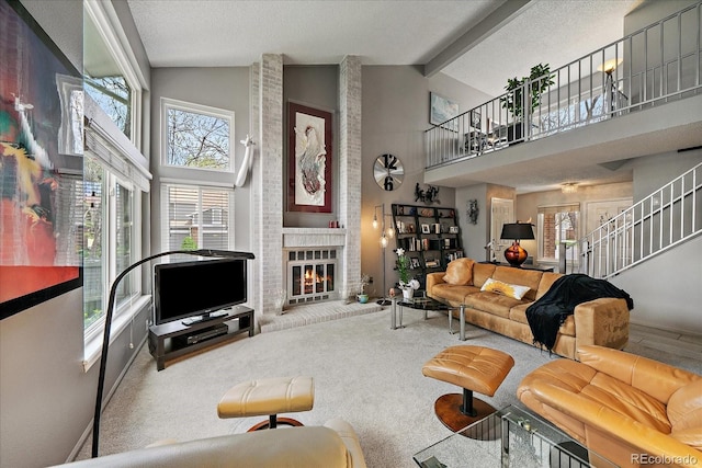 living area with a brick fireplace, a healthy amount of sunlight, high vaulted ceiling, and beamed ceiling