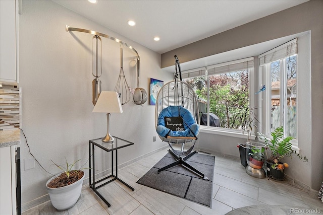 living area with recessed lighting and baseboards