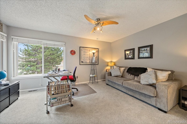 carpeted living room featuring a textured ceiling, ceiling fan, visible vents, and baseboards