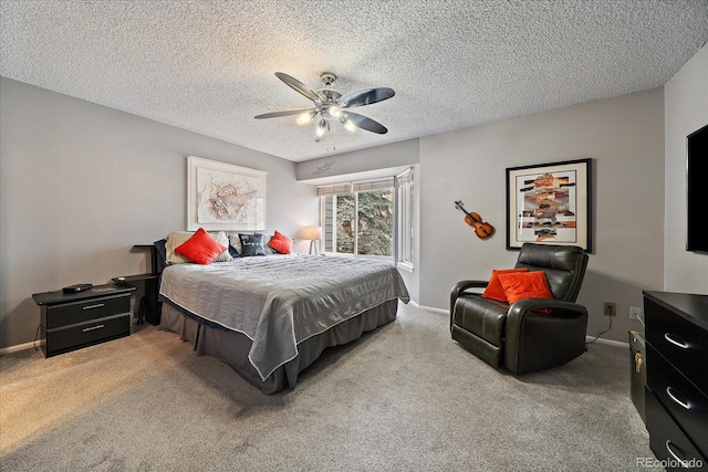 carpeted bedroom featuring baseboards, a textured ceiling, and ceiling fan