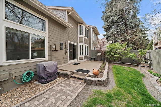 back of property with a fenced backyard and a patio area
