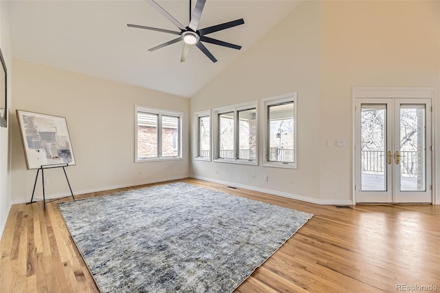 living room featuring wood-type flooring, ceiling fan, high vaulted ceiling, and french doors