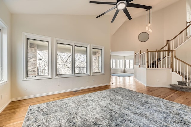 living room with ceiling fan, high vaulted ceiling, and light hardwood / wood-style flooring