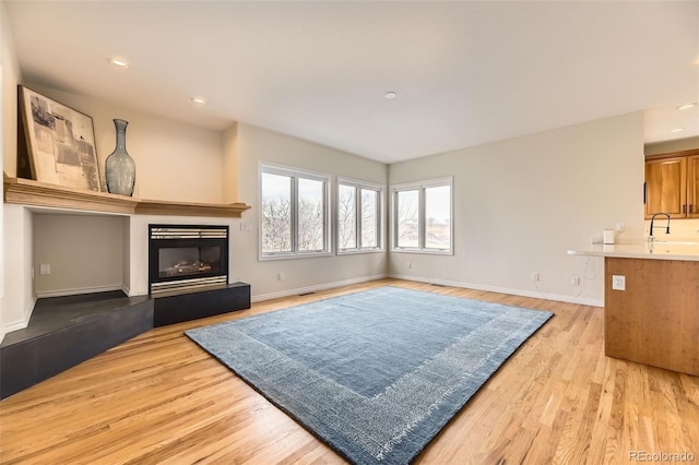 living room featuring sink and light wood-type flooring