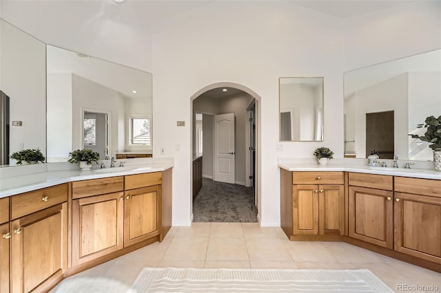 bathroom featuring vanity, lofted ceiling, and tile patterned floors