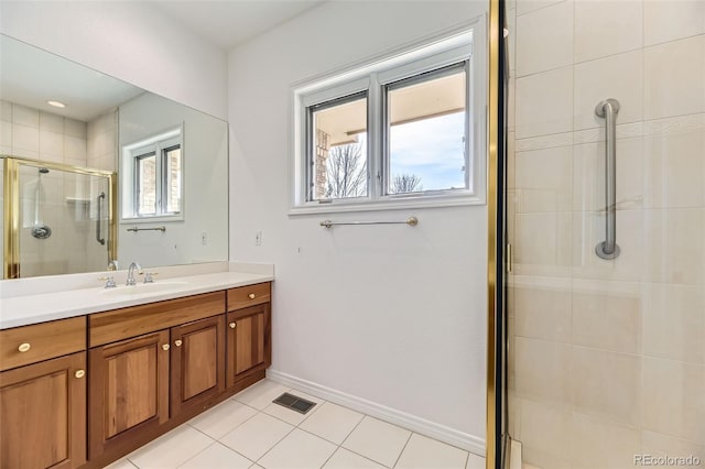 bathroom featuring tile patterned floors, vanity, and a shower with shower door