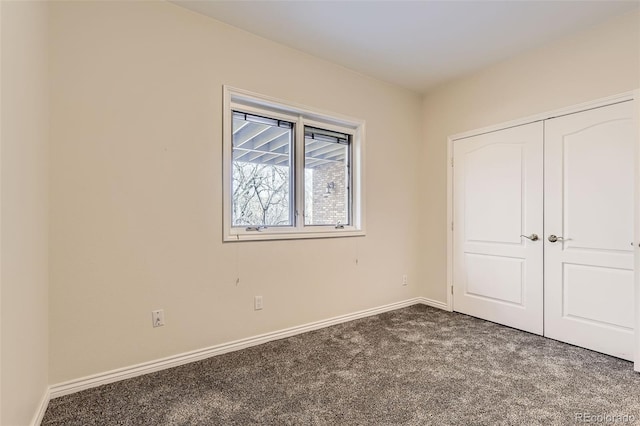 unfurnished bedroom featuring carpet floors and a closet