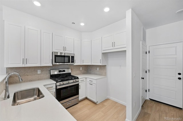 17123 W 91st Ln, Arvada, CO 80007 - kitchen featuring stainless steel appliances, light wood-style flooring, white cabinets, and recessed lighting