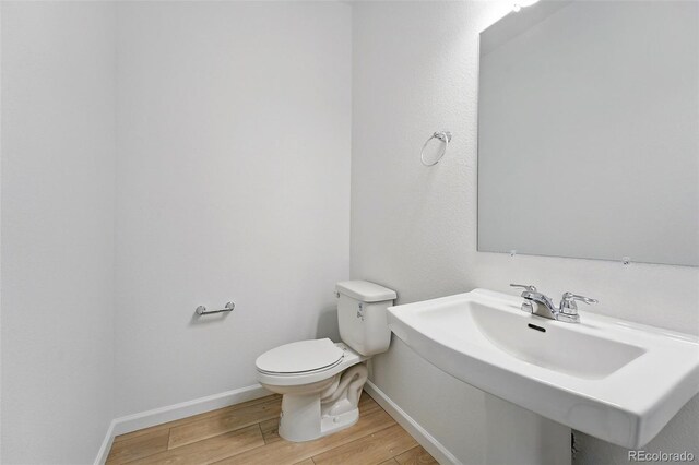17123 W 91st Ln, Arvada, CO 80007 - half bathroom with wood finished floors and toilet