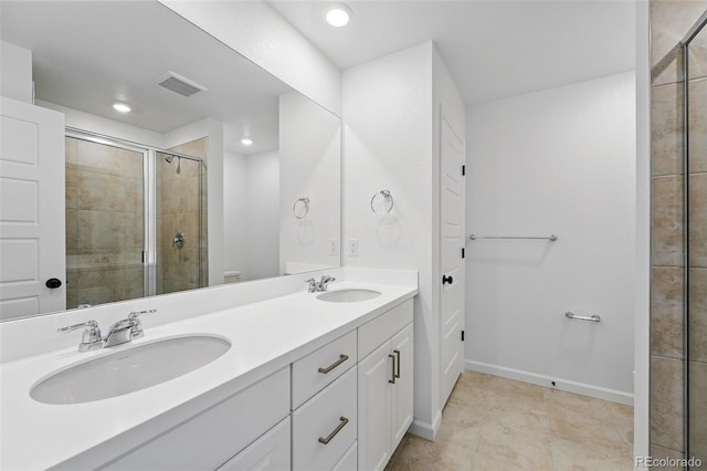 17123 W 91st Ln, Arvada, CO 80007 - bathroom featuring double vanity, a shower stall, recessed lighting, and tile patterned flooring