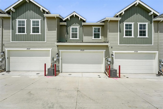 17123 W 91st Ln, Arvada, CO 80007 - view of front of home featuring board and batten siding, a garage, and concrete driveway
