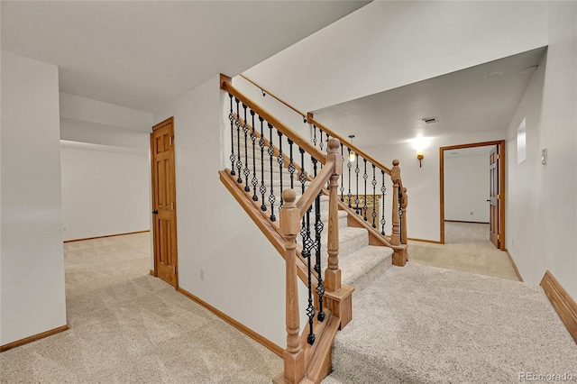 5722 W Chestnut Ave, Littleton, CO 80128 - staircase featuring carpet