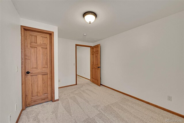 5722 W Chestnut Ave, Littleton, CO 80128 - unfurnished bedroom with baseboards and light colored carpet