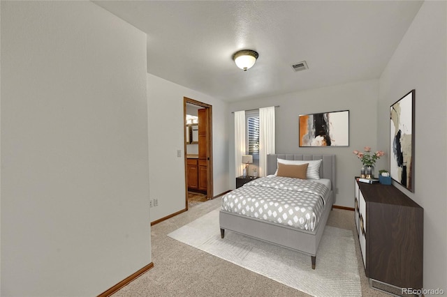 5722 W Chestnut Ave, Littleton, CO 80128 - bedroom with light carpet and ensuite bathroom
