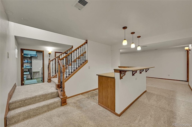 5722 W Chestnut Ave, Littleton, CO 80128 - indoor dry bar featuring light carpet, stairs, and decorative light fixtures