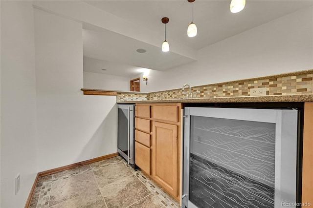 5722 W Chestnut Ave, Littleton, CO 80128 - kitchen featuring wine cooler, stone tile floors, pendant lighting, and light brown cabinetry