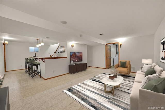 5722 W Chestnut Ave, Littleton, CO 80128 - living area featuring washer / dryer, light colored carpet, and stairs