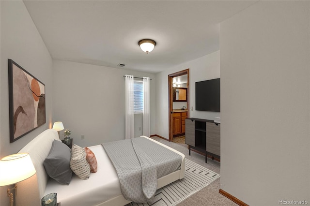 5722 W Chestnut Ave, Littleton, CO 80128 - bedroom with light colored carpet and ensuite bathroom