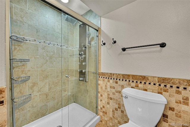 5722 W Chestnut Ave, Littleton, CO 80128 - full bathroom with tile walls, a shower stall, and wainscoting