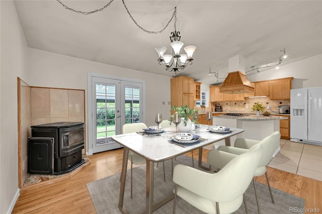 5722 W Chestnut Ave, Littleton, CO 80128 - dining space with french doors, a chandelier, track lighting, and light wood finished floors