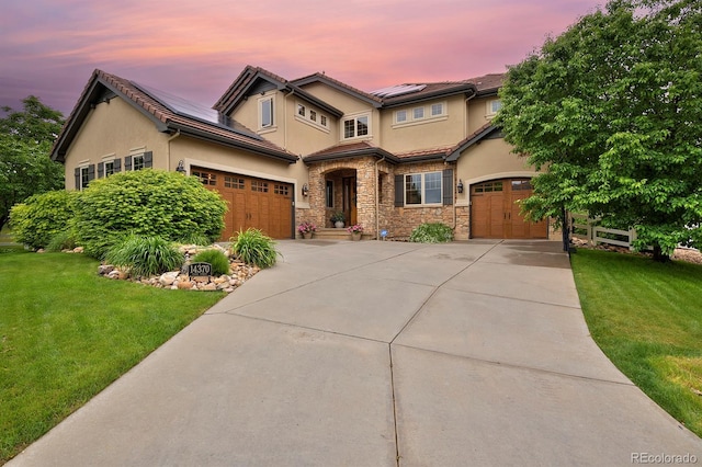 14370 Osage St, Westminster, CO 80023 - view of front facade featuring driveway, a front yard, stucco siding, and solar panels