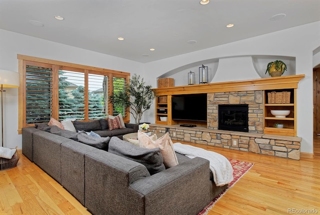 14370 Osage St, Westminster, CO 80023 - living area featuring wood finished floors, a stone fireplace, and recessed lighting
