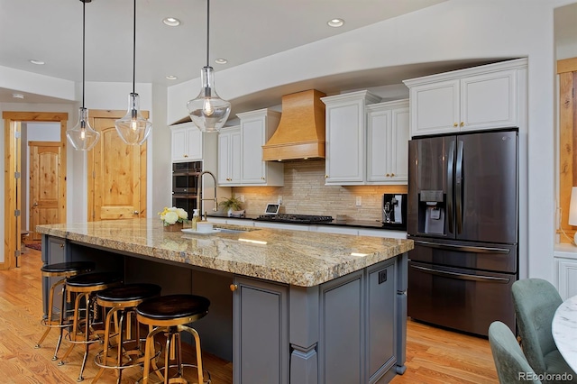 14370 Osage St, Westminster, CO 80023 - kitchen featuring refrigerator with ice dispenser, custom range hood, double oven, white cabinets, and recessed lighting