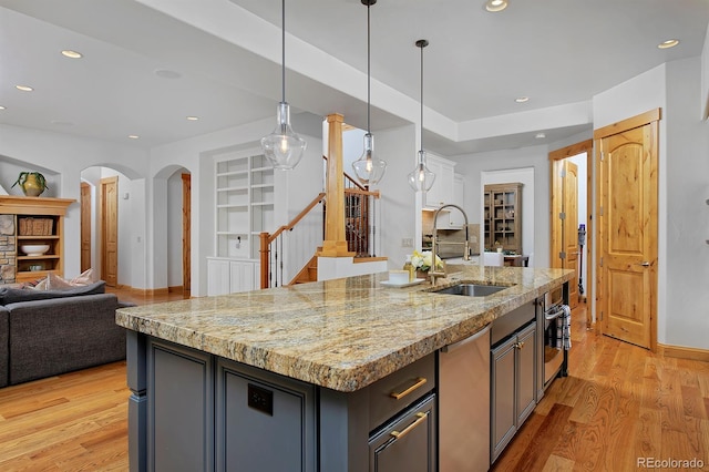 14370 Osage St, Westminster, CO 80023 - kitchen with a sink, open floor plan, an island with sink, light wood finished floors, and recessed lighting