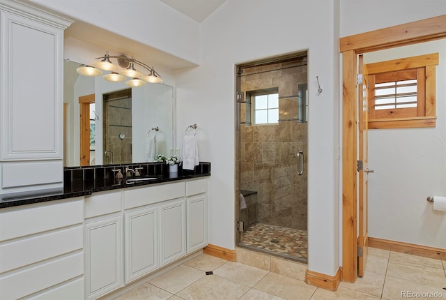 14370 Osage St, Westminster, CO 80023 - bathroom featuring baseboards, a shower stall, vanity, and tile patterned flooring