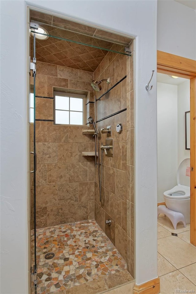 14370 Osage St, Westminster, CO 80023 - bathroom featuring toilet, a shower stall, and tile patterned flooring
