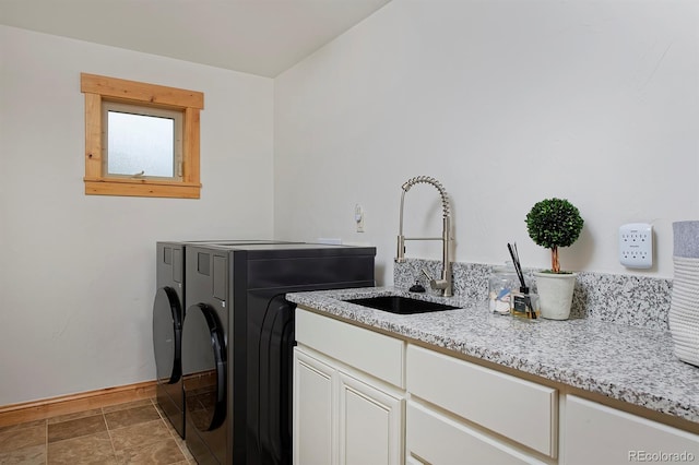 14370 Osage St, Westminster, CO 80023 - washroom with cabinet space, washer and clothes dryer, and baseboards